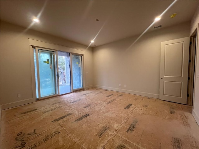 empty room with recessed lighting, visible vents, and baseboards