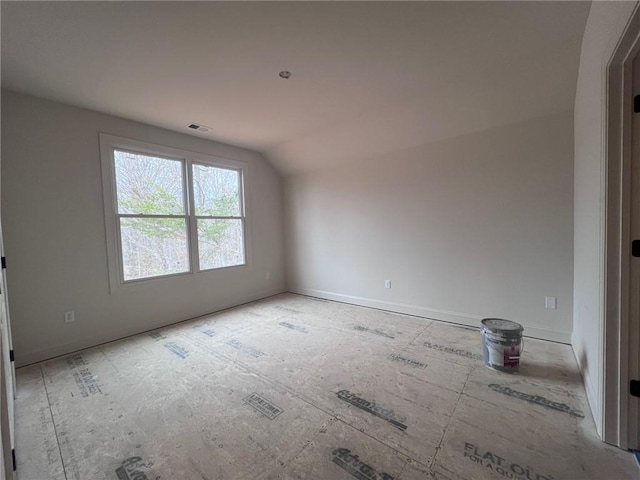 spare room with lofted ceiling and visible vents