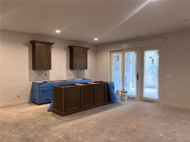 kitchen with recessed lighting, dark brown cabinetry, and baseboards