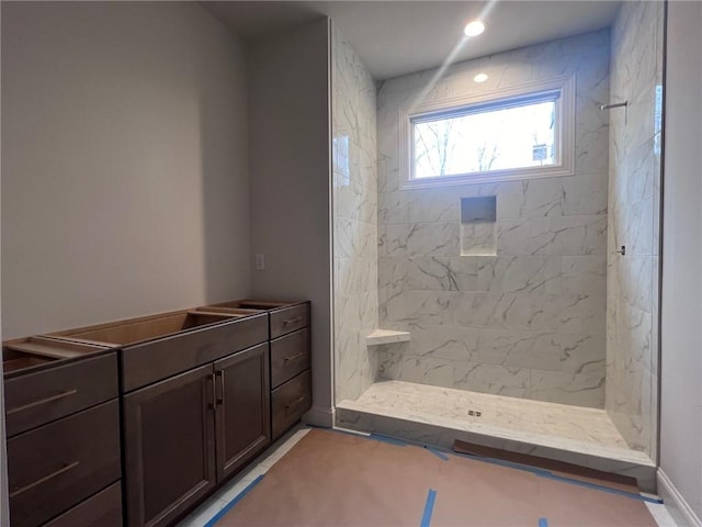 bathroom with a tile shower