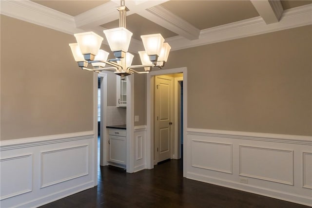 unfurnished dining area featuring a chandelier, beam ceiling, dark wood finished floors, and ornamental molding