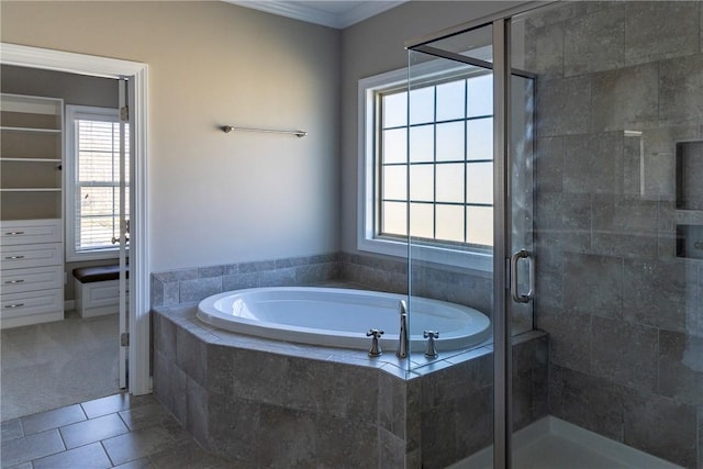 full bath featuring tile patterned flooring, a shower stall, a bath, and crown molding