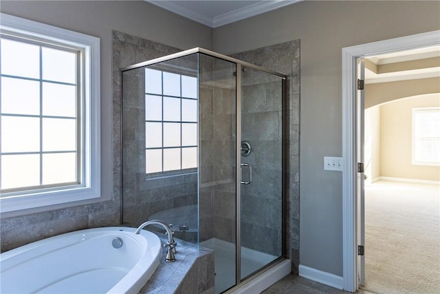 full bath featuring ornamental molding, a garden tub, a shower stall, and baseboards