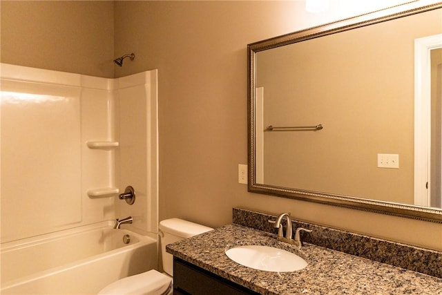 bathroom featuring toilet, washtub / shower combination, and vanity