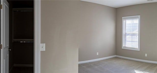 unfurnished room featuring visible vents, baseboards, and light colored carpet