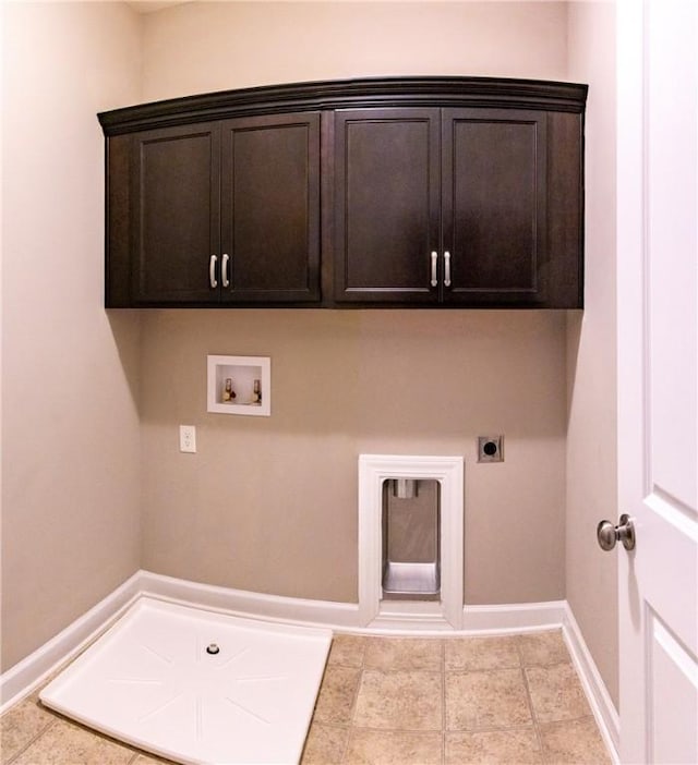 washroom featuring cabinet space, baseboards, washer hookup, electric dryer hookup, and light tile patterned flooring