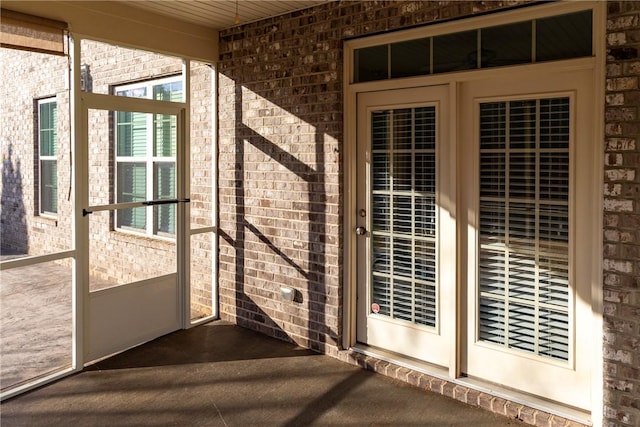 entrance to property featuring brick siding