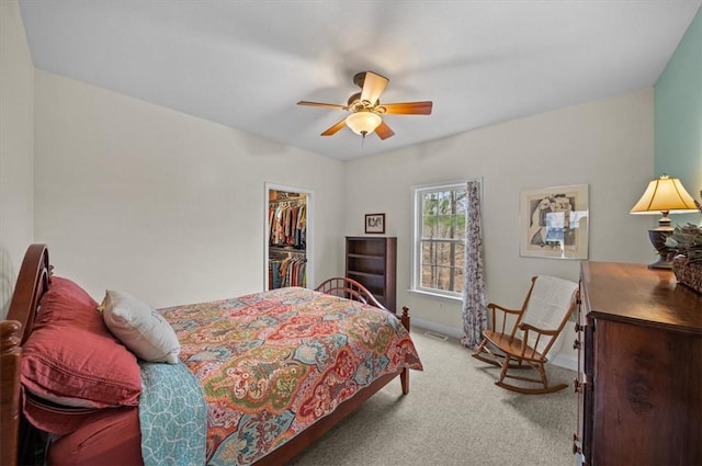 bedroom with visible vents, baseboards, carpet, a walk in closet, and a closet