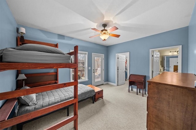 carpeted bedroom featuring access to exterior, baseboards, and a ceiling fan