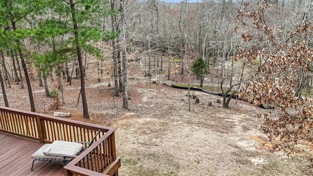 exterior space with a deck and a wooded view