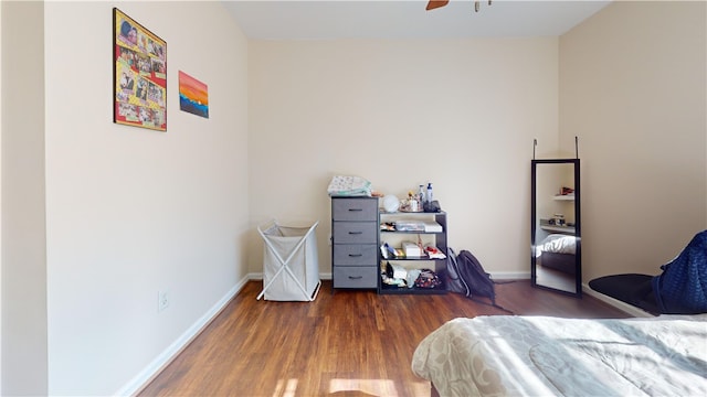 bedroom featuring a ceiling fan, baseboards, and wood finished floors