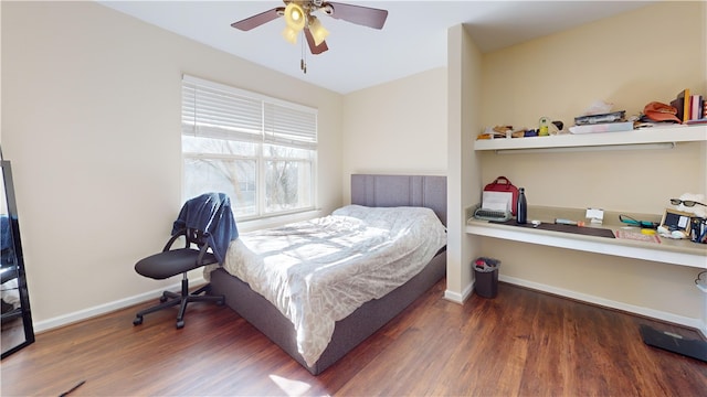 bedroom featuring a ceiling fan, baseboards, and wood finished floors