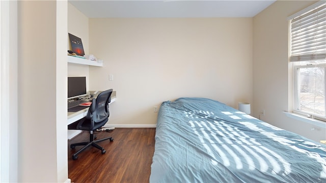 bedroom featuring baseboards and wood finished floors