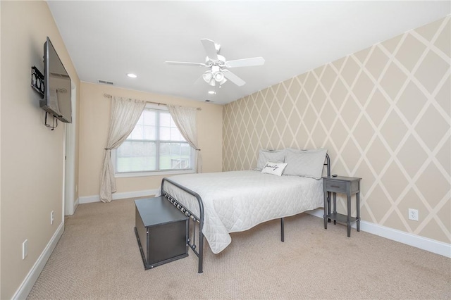 bedroom featuring visible vents, wallpapered walls, an accent wall, baseboards, and carpet