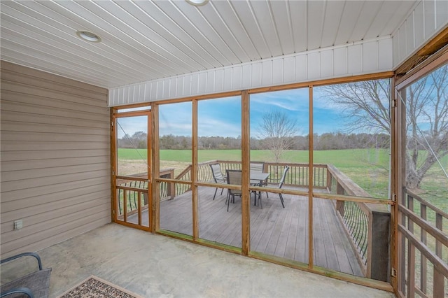 unfurnished sunroom with a rural view