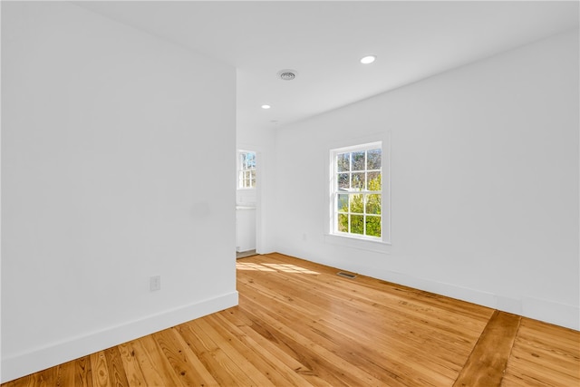 spare room featuring recessed lighting, light wood-style floors, visible vents, and baseboards