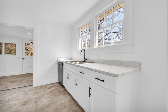 kitchen with a sink, stainless steel dishwasher, white cabinets, crown molding, and baseboards