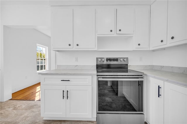 kitchen featuring white cabinetry, light stone countertops, and stainless steel range with electric cooktop