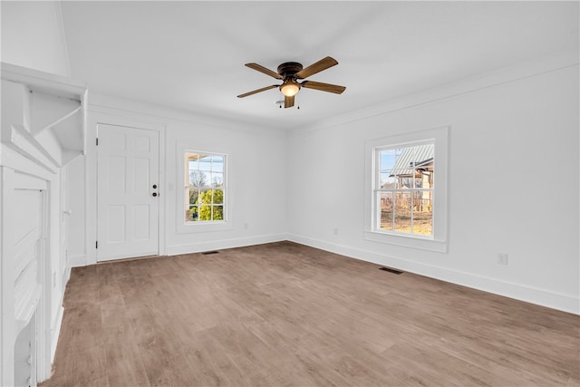 unfurnished room with a ceiling fan, baseboards, visible vents, and light wood finished floors