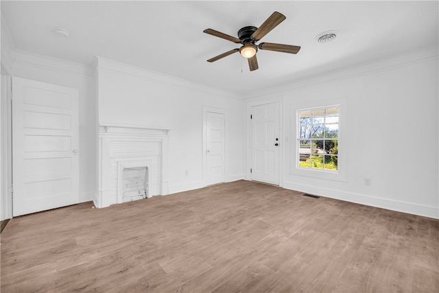 unfurnished living room with visible vents, baseboards, wood finished floors, and crown molding