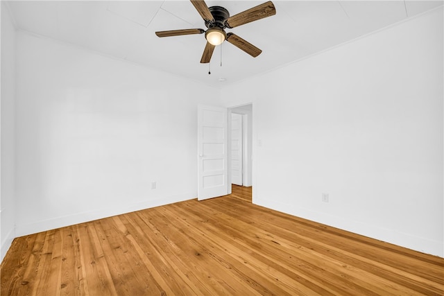 unfurnished room featuring baseboards, light wood-type flooring, and ceiling fan