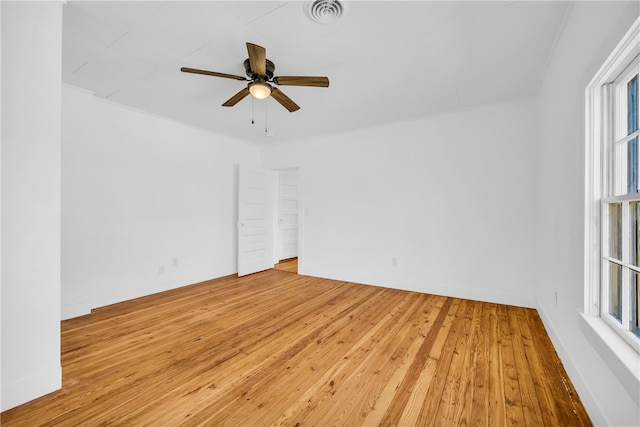 empty room with ceiling fan, visible vents, and light wood-style flooring