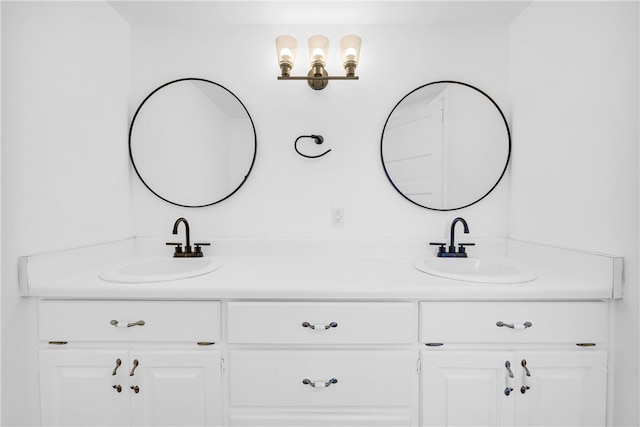 bathroom featuring a sink and double vanity