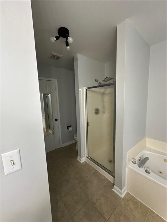 full bath with visible vents, a stall shower, a whirlpool tub, tile patterned flooring, and toilet