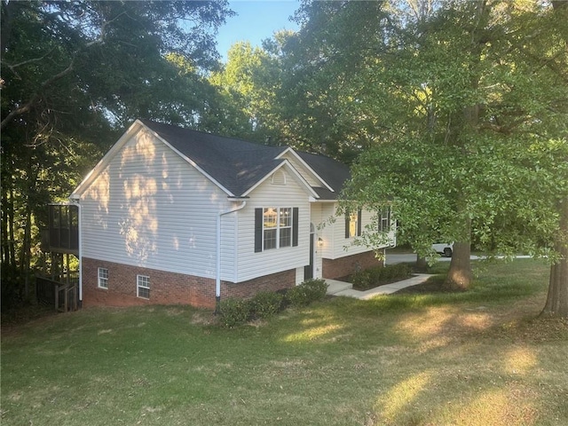 view of side of home with a yard