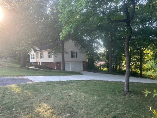 view of property exterior with concrete driveway, a lawn, and a garage