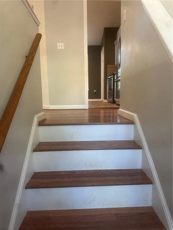 stairway featuring wood finished floors