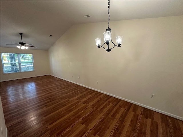 unfurnished room with visible vents, baseboards, dark wood finished floors, and vaulted ceiling