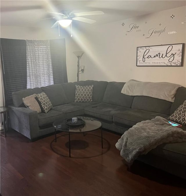 living area with wood finished floors and ceiling fan