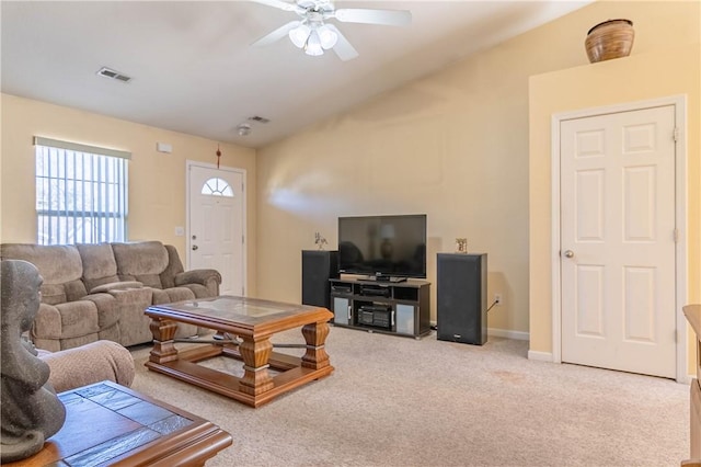 carpeted living area with visible vents, baseboards, ceiling fan, and vaulted ceiling