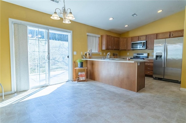 kitchen featuring visible vents, light countertops, lofted ceiling, appliances with stainless steel finishes, and brown cabinetry