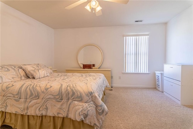 bedroom featuring visible vents, light colored carpet, baseboards, and a ceiling fan