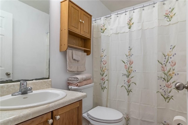 full bathroom with vanity, a shower with shower curtain, and toilet