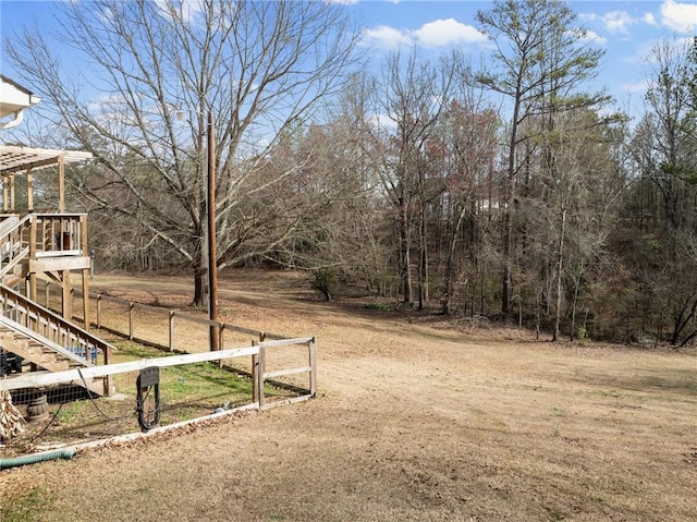 view of yard with stairway and fence