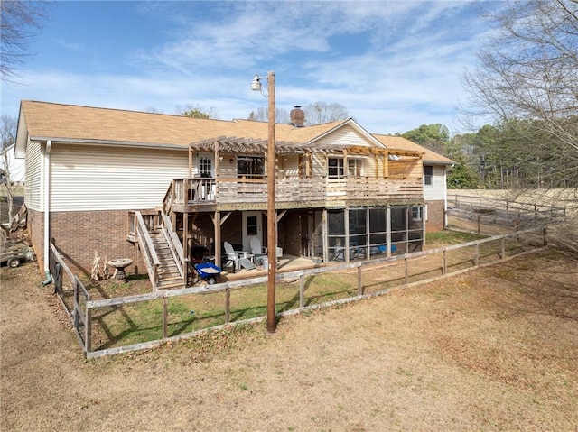 back of house with brick siding, fence, stairs, a chimney, and a sunroom