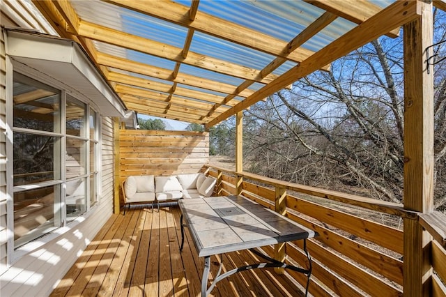 wooden deck featuring an outdoor living space and a pergola