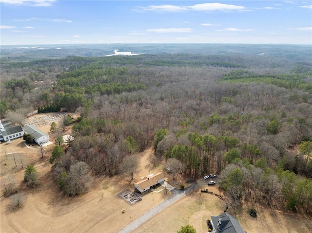 bird's eye view featuring a wooded view