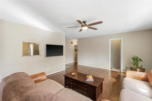 living room featuring baseboards, ceiling fan, lofted ceiling, wood finished floors, and a textured ceiling