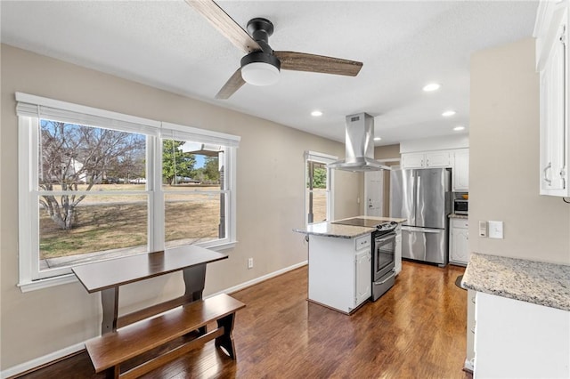 kitchen with island exhaust hood, appliances with stainless steel finishes, white cabinets, and dark wood-style flooring