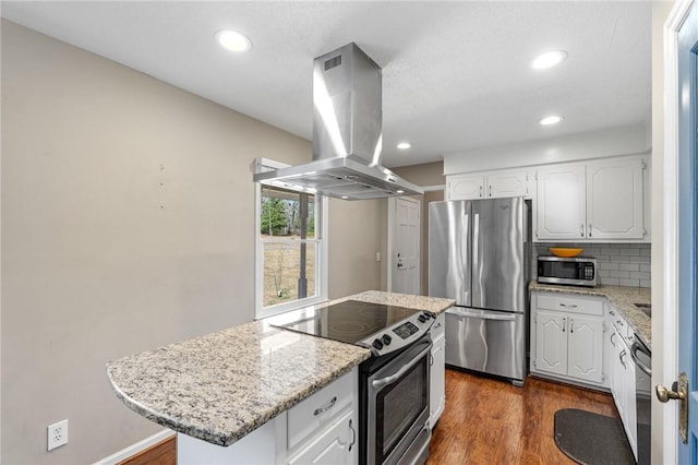 kitchen with dark wood-style floors, white cabinetry, stainless steel appliances, island range hood, and decorative backsplash