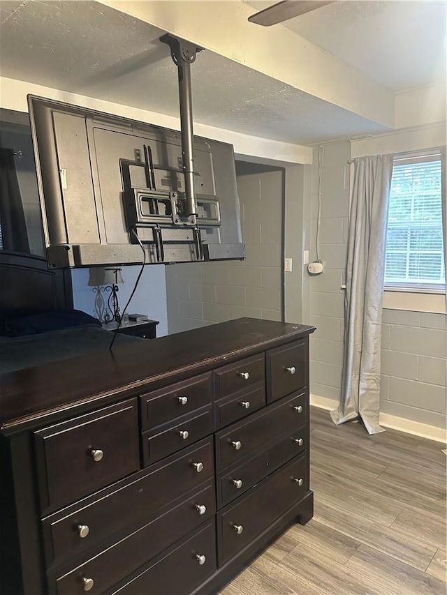 room details with concrete block wall and wood finished floors