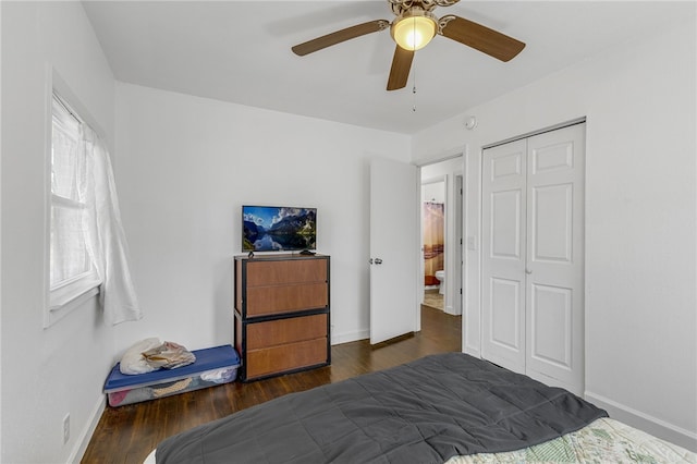 bedroom featuring a closet, baseboards, wood finished floors, and a ceiling fan