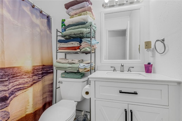 bathroom featuring vanity and toilet