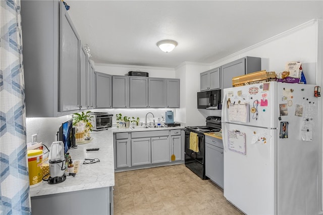 kitchen with gray cabinetry, black appliances, crown molding, and a sink