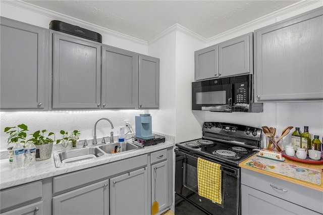 kitchen with black appliances, gray cabinetry, and a sink