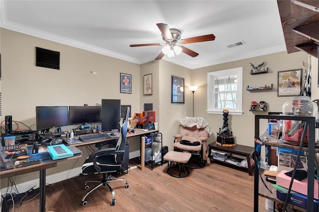 office space featuring ceiling fan, wood finished floors, visible vents, and ornamental molding